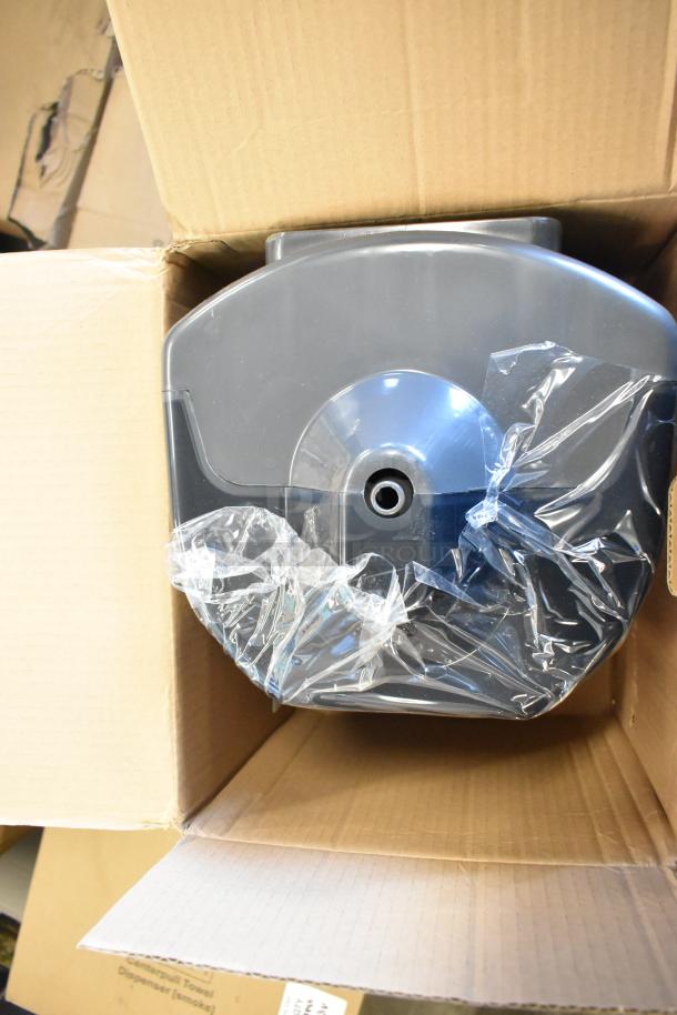 Brand new center pull towel dispenser in a box, partially wrapped in plastic, labeled as scratch and dent. 23 available.