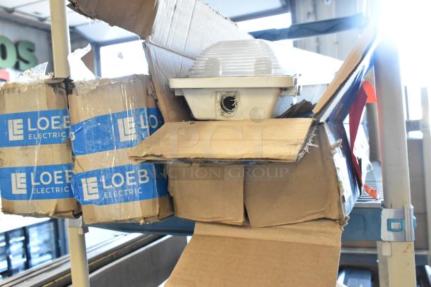 Four Loeb Electric light fixtures in original packaging, lightly worn boxes, ready for installation.