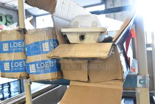 Four Loeb Electric light fixtures in original packaging, lightly worn boxes, ready for installation.