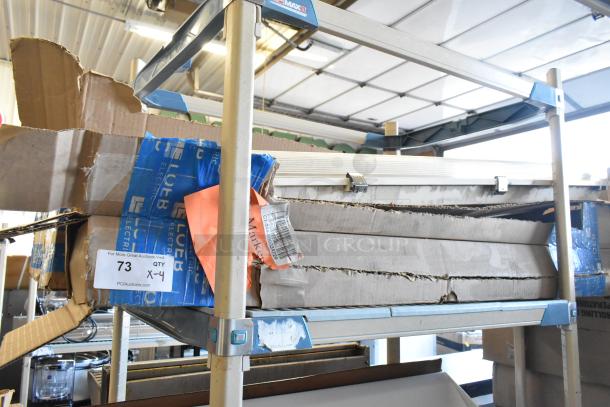 Four packaged light fixtures on a warehouse shelf. Boxes show wear; labeled "LuEB Electric." Includes auction tag: "QTY 4."