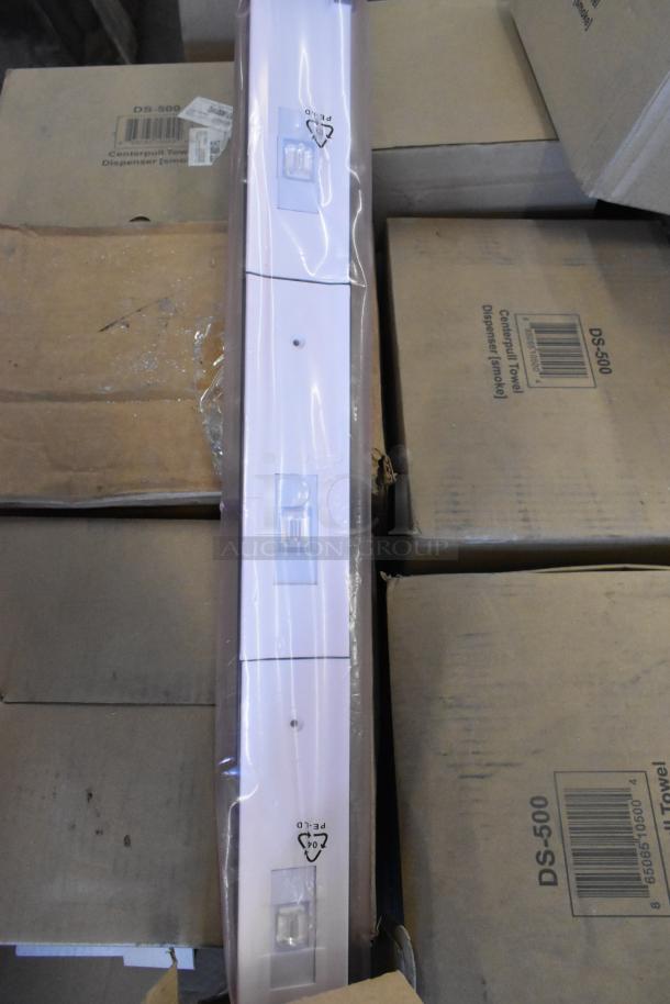 Seven new light fixtures in packaging, featuring a sleek white design. Items are stacked on boxes, with visible PE-LD recycling symbol.