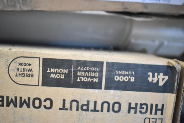 Box of light fixtures labeled "8,000 lumens, 4000K, Row Mount, M-Volt Driver, 4ft."