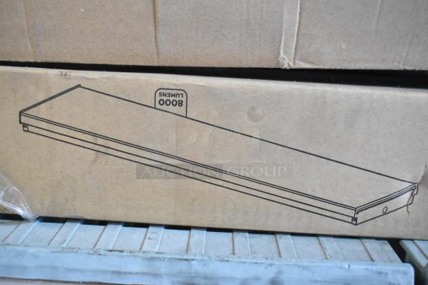Cardboard box with illustration of a long light fixture. Marked "8000 Lumens." Contains 7 various light fixtures.