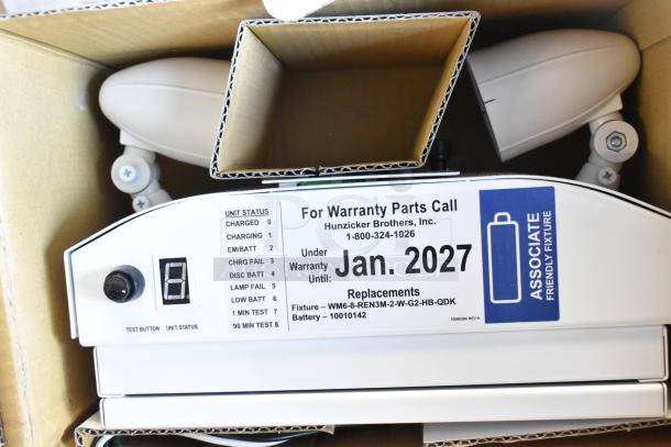 Dual Lite LED Emergency Light in box, warranty tag for Jan 2027, includes test button and unit status indicator.