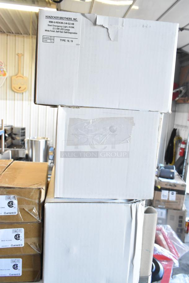 Stack of boxes containing Dual Lite LED Emergency Lights, models EVHCEZP. Boxes show some wear, labels indicate model and specs.