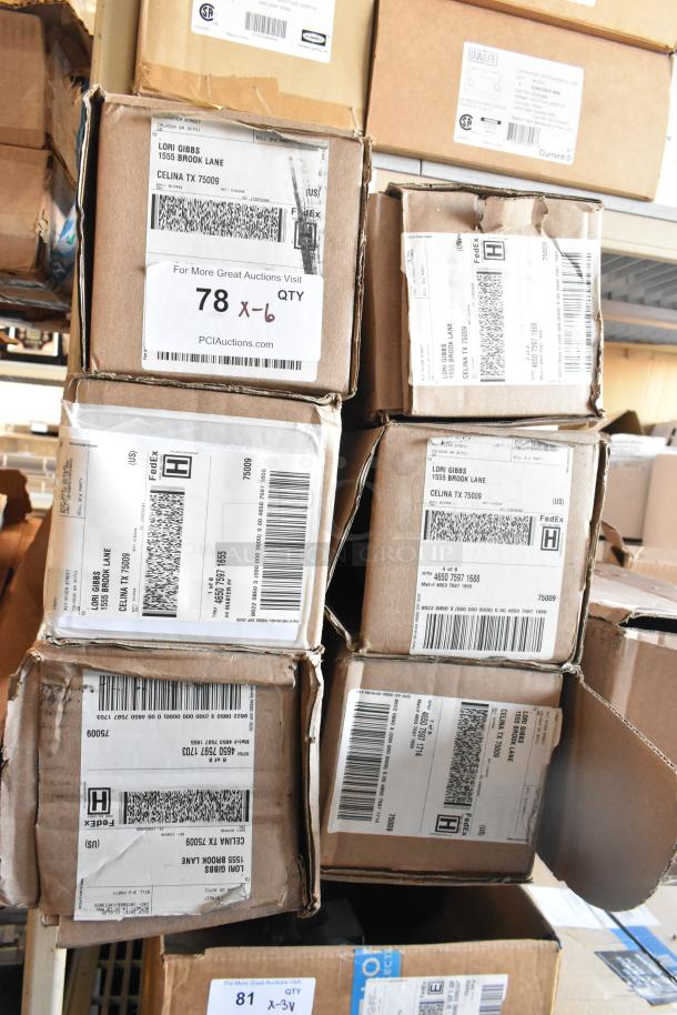 Stacked boxes labeled "78 x 6 QTY" at an auction. Contains black floor mats, new condition.