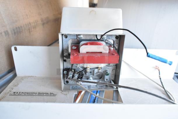 Inside view of an electrical component featuring wiring and parts, labeled M & S Refrigeration Systems, Inc. Used condition.