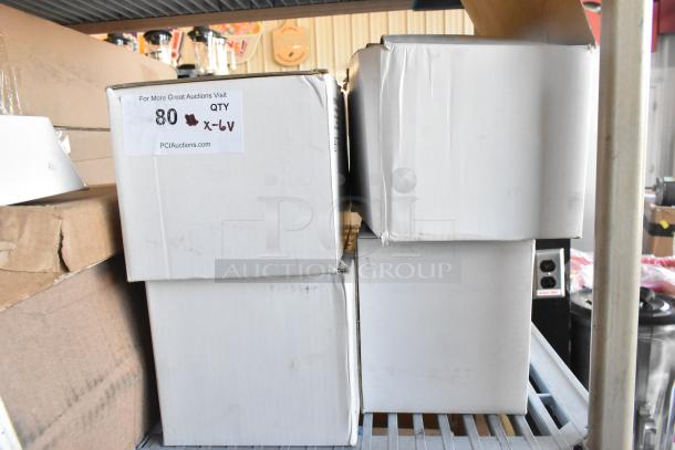 Six white boxes stacked on a shelf, marked "80 QTY X-6V" indicating auction info. Includes emergency light among items.