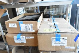 Cardboard boxes containing Current Evolve LED flood lights, labeled with model and quantity, new in packaging.