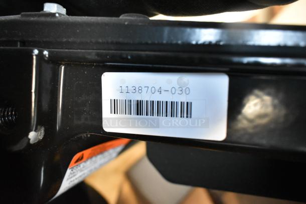 Barcode label on black metal frame, showing number 1138704-030. Part of auction lot with LED flood lights.