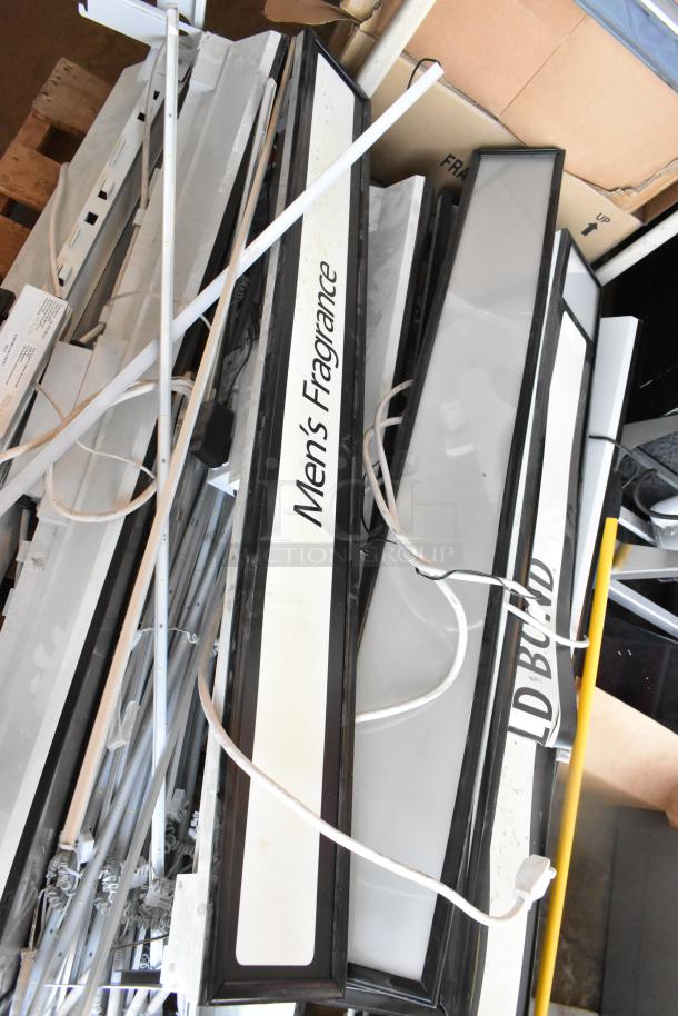Eight rectangular light fixtures, some labeled "Men's Fragrance," with cords. Mixed condition, ideal for retail displays.