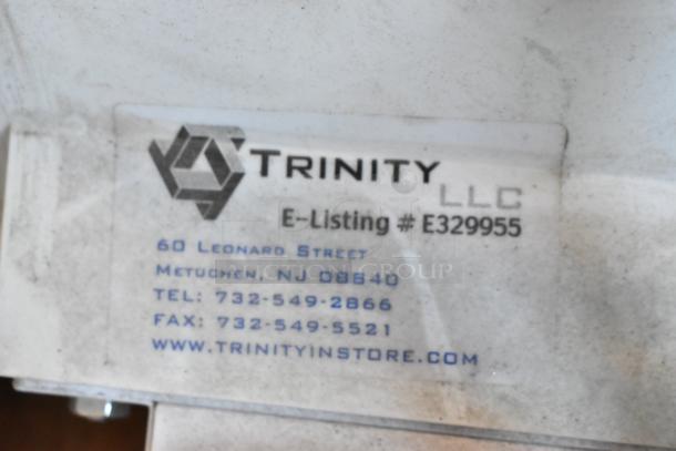 Trinity LLC label on light fixture, E-Listing #E329955, Metuchen, NJ contact details visible.