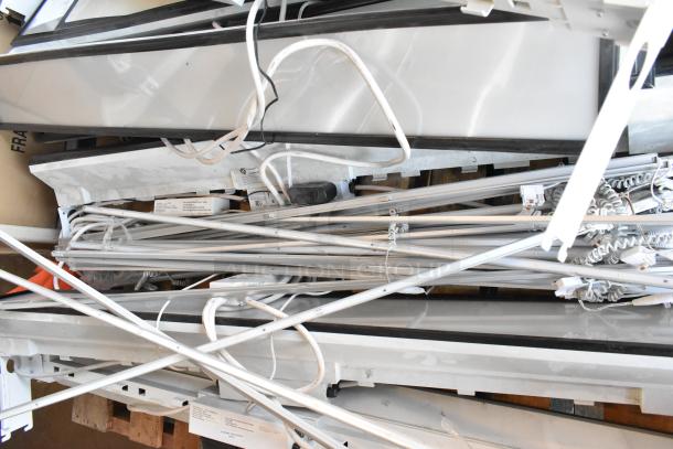 Eight fluorescent light fixtures with wiring, various parts visible; suitable for bulk purchase and installation.