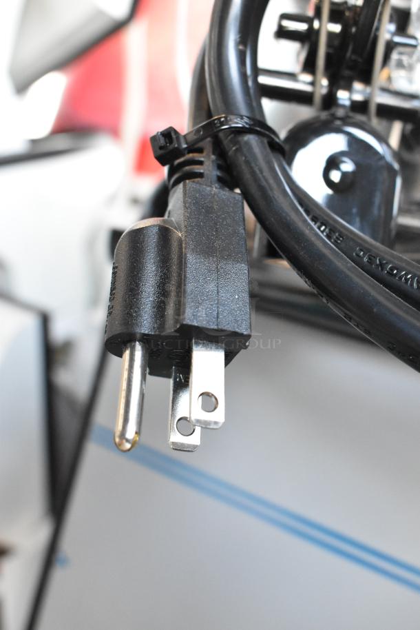 Black power cord with plug for the Narvon 378NSSM2 commercial beverage machine. Securely tied with a zip tie.