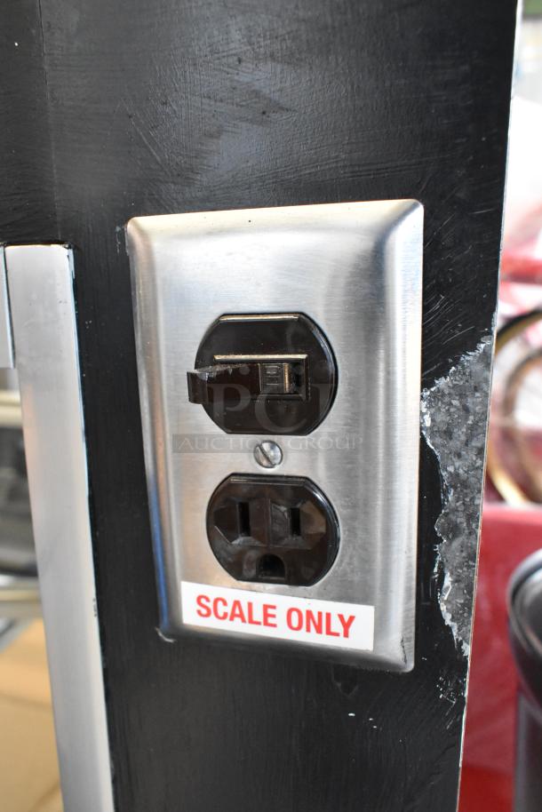 Metal commercial display case with outlet labeled "Scale Only," by Cooking Performance Group. Durable and functional.