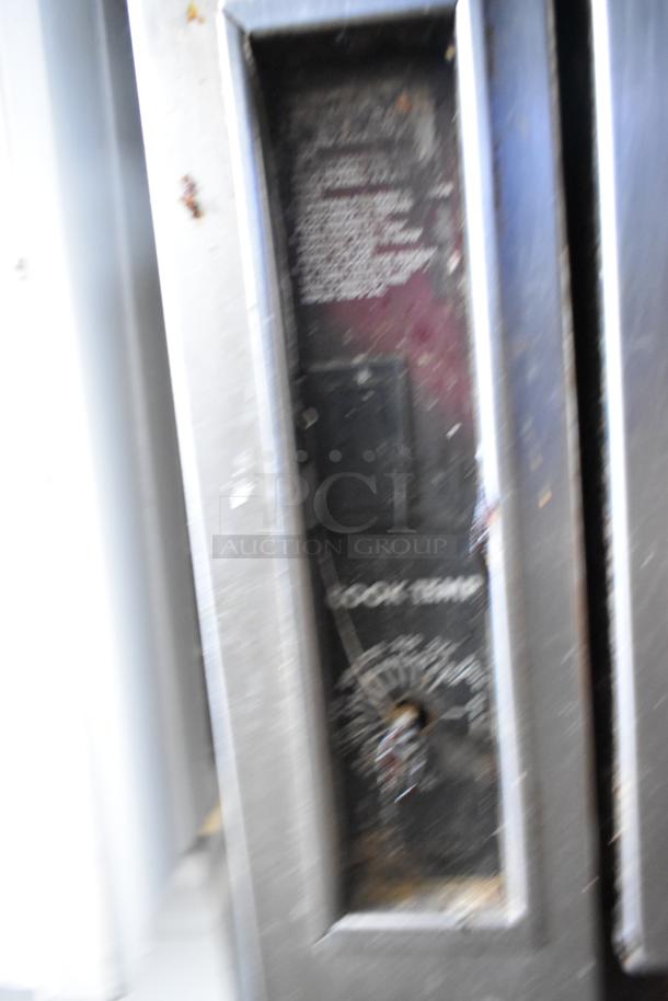 Southbend commercial gas range control panel, stainless steel, shows temperature settings. Signs of wear visible.