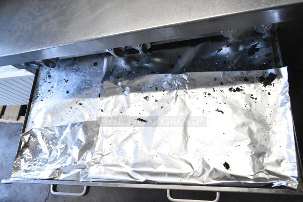 Southbend stainless steel commercial gas-powered 6 burner range with oven and backsplash, showing surface wear.