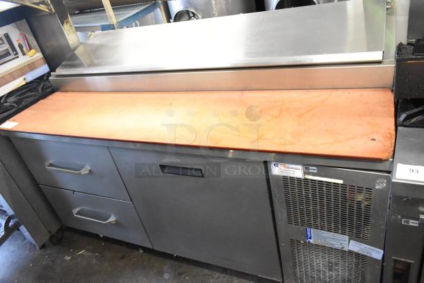 Delfield stainless steel commercial pizza prep table, 115 volts, 1 phase, features a cutting surface, and storage drawers.