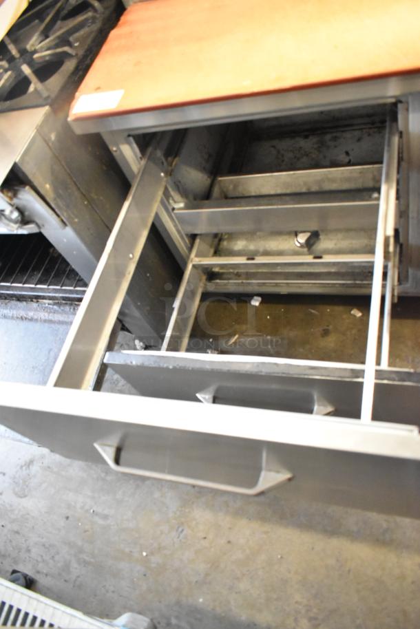 Delfield stainless steel commercial pizza prep table, open drawer view, 115 volts, 1 phase, showing sturdy construction.