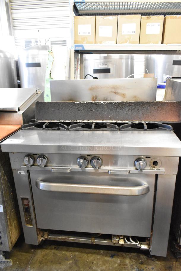 Southbend P36G-BBB stainless steel 6-burner range with oven, commercial natural gas, visible wear, sturdy design.