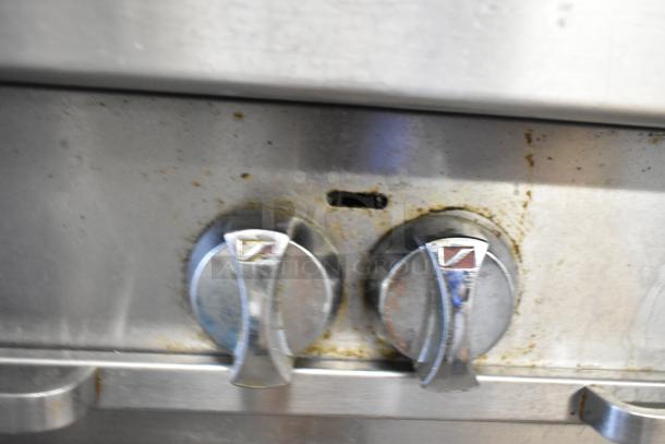 Southbend P36G-BBB stainless steel range knobs, showing wear and grease buildup.