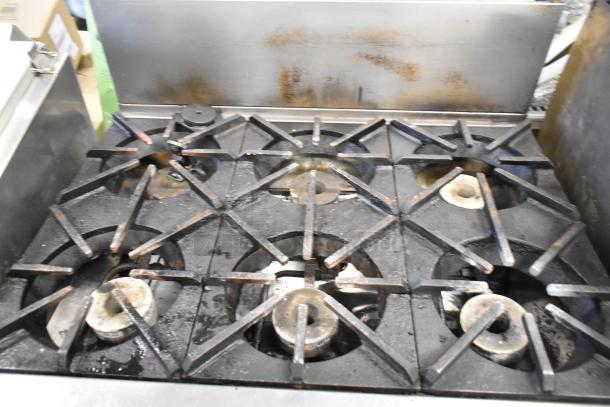 Southbend P36G-BBB stainless steel 6-burner range with oven, natural gas, used condition, visible signs of wear.