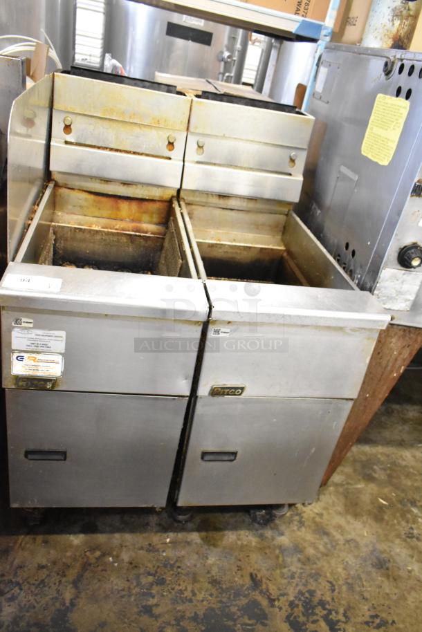 2 Pitco Frialator stainless steel commercial floor deep fat fryers, visible wear, labels indicate model and maintenance info.