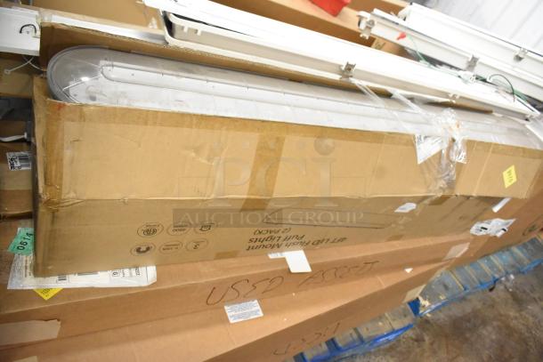Cardboard boxes containing 24 light fixtures, labeled "LED Flush Mount Puff Lights," some marked as used assets.