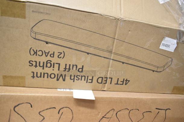 Cardboard boxes containing 24 items, including LED flush mount light fixtures. Visible box with "2 Pack" marking.
