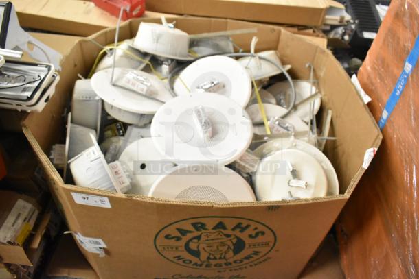 Auction lot of 36 Wheelock CBB-8 speaker enclosures with fire alarm lights, boxed, mixed condition, some with visible "FIRE" markings.