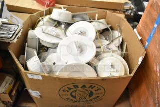 Auction lot of 36 Wheelock CBB-8 speaker enclosures with fire alarm lights, boxed, mixed condition, some with visible "FIRE" markings.