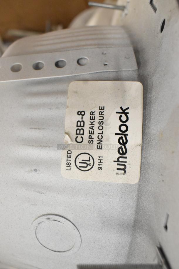 36 Wheelock CBB-8 speaker enclosures with fire alarm lights, UL listed. Label indicates item type and certification.