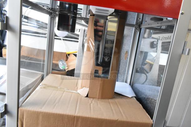 Carnival King 382PM1360 popcorn machine, brand new, scratch and dent condition, with visible packaging inside, model label shown.