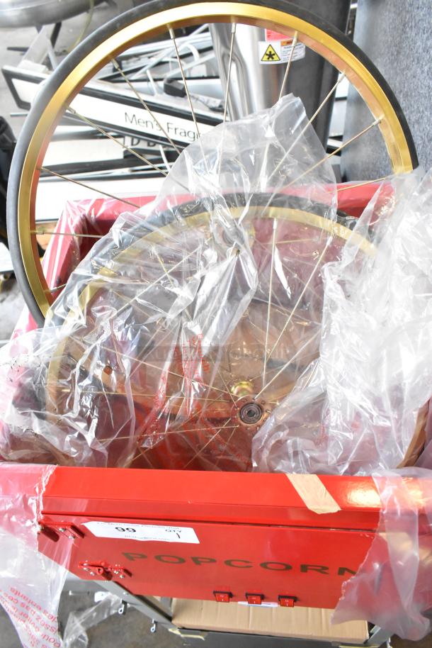 Brand new Carnival King 382PM1360 metal commercial 12 oz. popcorn machine, red exterior, with plastic wrap and slight packaging dent.