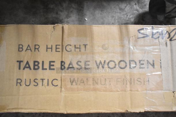 Brand new Lancaster bar height table base in rustic walnut finish, scratch and dent condition, visible label on box.