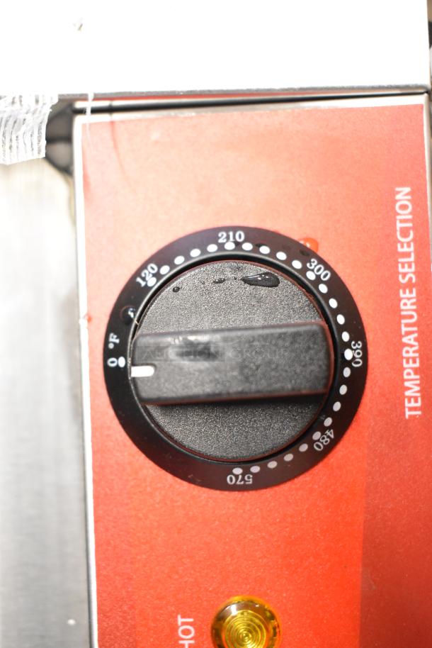 Close-up of the temperature dial on a 2023 Avantco 177PG400S stainless steel dual panini grill, highlighting temperature selection.