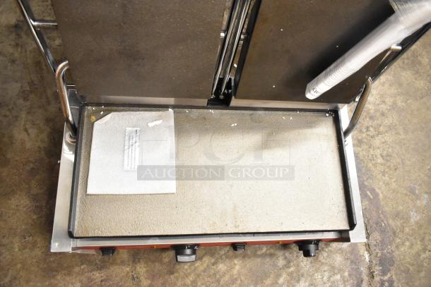 Brand new Avantco 177PG400S commercial panini grill, smooth plates, 19 5/8" x 9 1/8" surface, 120V, with minor scratches.
