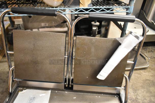 Brand new Avantco 177PG400S commercial dual panini grill with smooth plates, 19 5/8" x 9 1/8" surface, stainless steel.