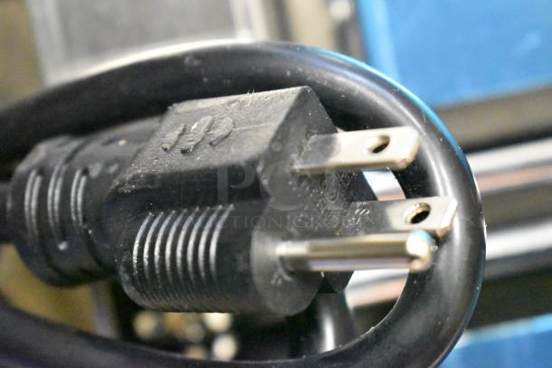 Close-up of a black power cord plug for the 2023 Avantco 177PG400S Panini Grill, showing standard prongs.