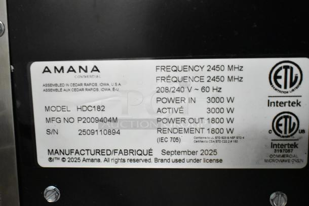 Amana HDC182 stainless steel commercial microwave, 2025 model. Features 208/240V, push-button controls, labels show 2450 MHz frequency. New with scratches.