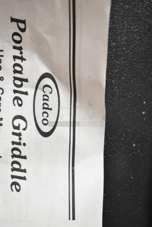 Brand new Cadco PCG-10C countertop griddle, 21"x12", light-duty, 120V, scratch and dent condition, instruction label shown.