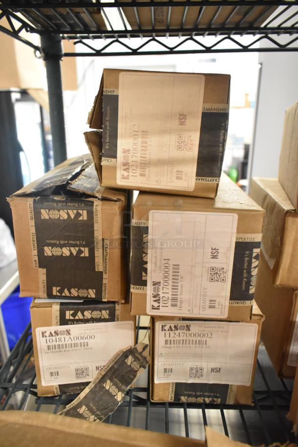 Six Kason items in boxes, including a door hinge and release handle, marked new with minor dents. NSF certified labels shown.