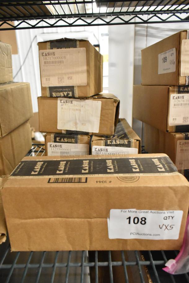 Boxes of brand new Kason items including caulk, door handles, and hex foot inserts. Labels show model numbers and quantities.