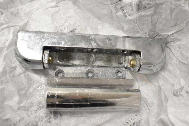 6 new scratch and dent items, including Kason door handle, on crumpled paper. Unused, visible bolts and packaging.