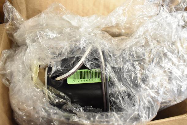 Brand new scratch and dent remote fan motor in protective plastic wrap, barcode G1244470716 visible.