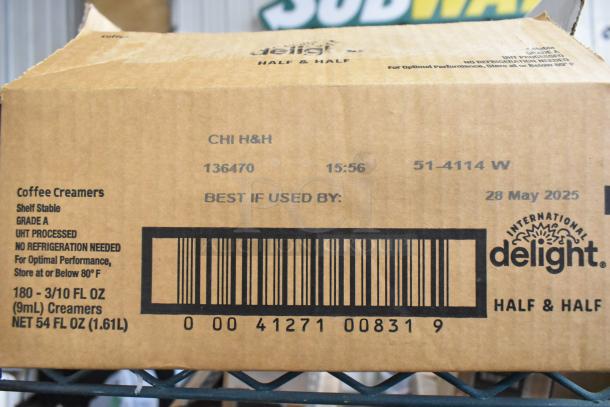 Cardboard box of International Delight Half & Half Coffee Creamers, shelf stable, 180 units, best by May 28, 2025. Barcodes visible.