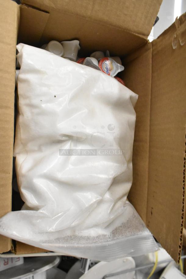 Box containing brand new Kason door catches and strikes. Items are labeled "scratch and dent" but appear unused.