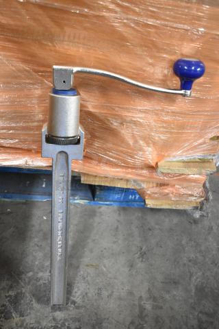 Metal can opener by Edlund Co. with blue handle, sturdy construction, marked "Burlington, VT U.S.A.," in used condition.