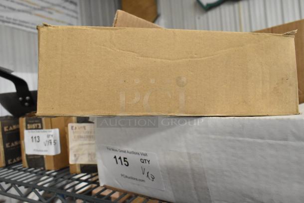 Cardboard boxes on a metal shelf, containing various auction items including a metal can opener and a microphone. Tags display auction details.