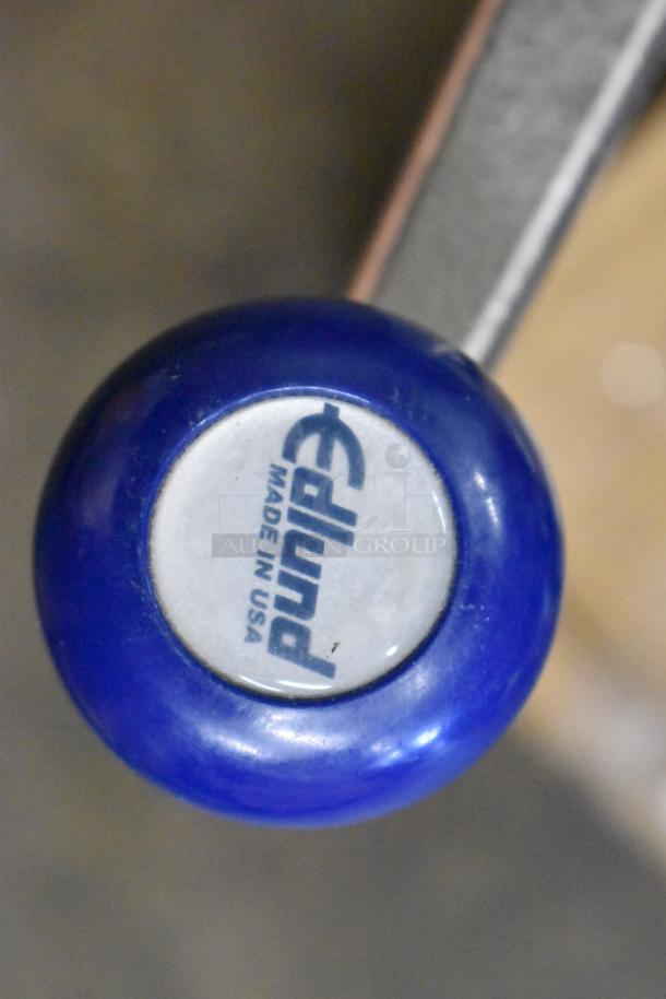 Metal can opener with blue handle marked "Edlund, Made in USA," part of a 3-item auction set.